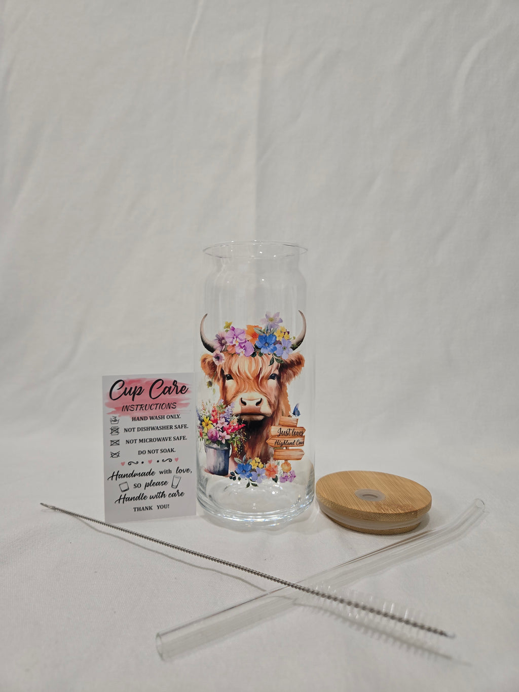 Highland Glass Cup, 20 oz, " Just Loves Highland Cows" on a wood sign and flower